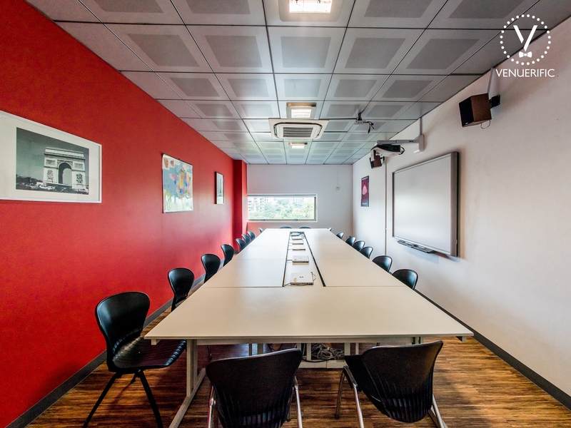 small private meeting room in singapore with white board and red wall