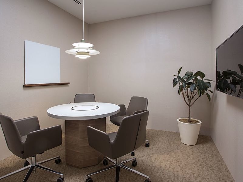 small meeting room in singapore with round table and white board