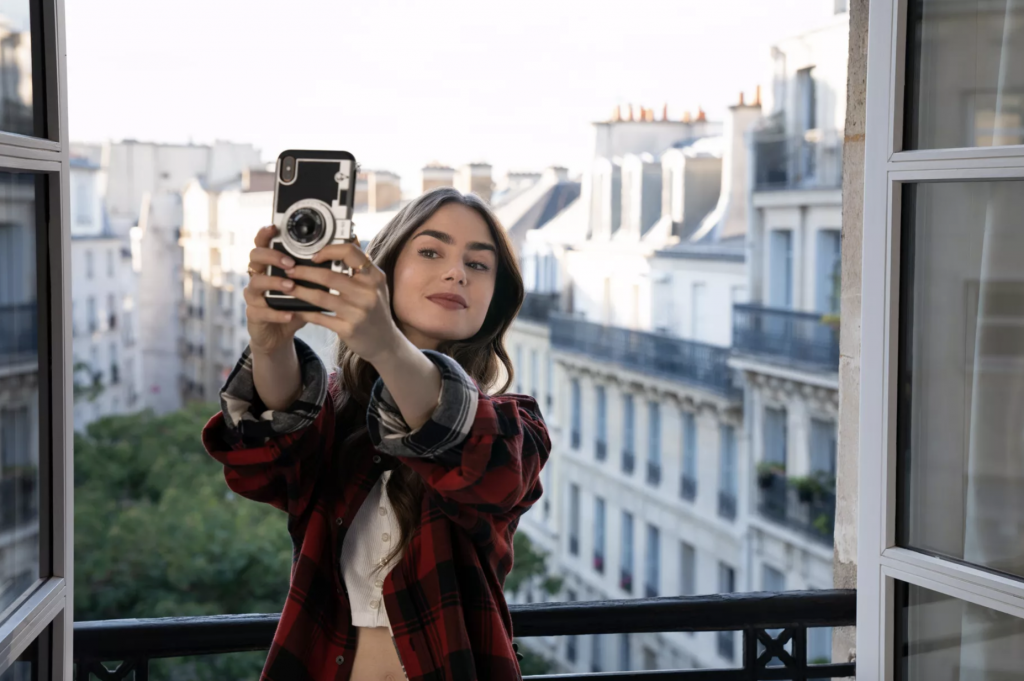lily collins taking a picture in paris balcony