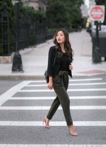 lady walking across the street with black top and pants