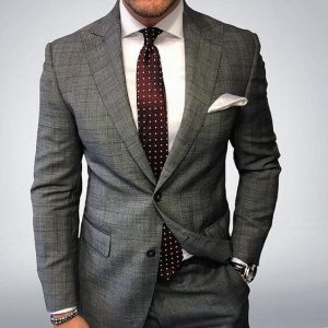 man in a grey suit and tie outfit