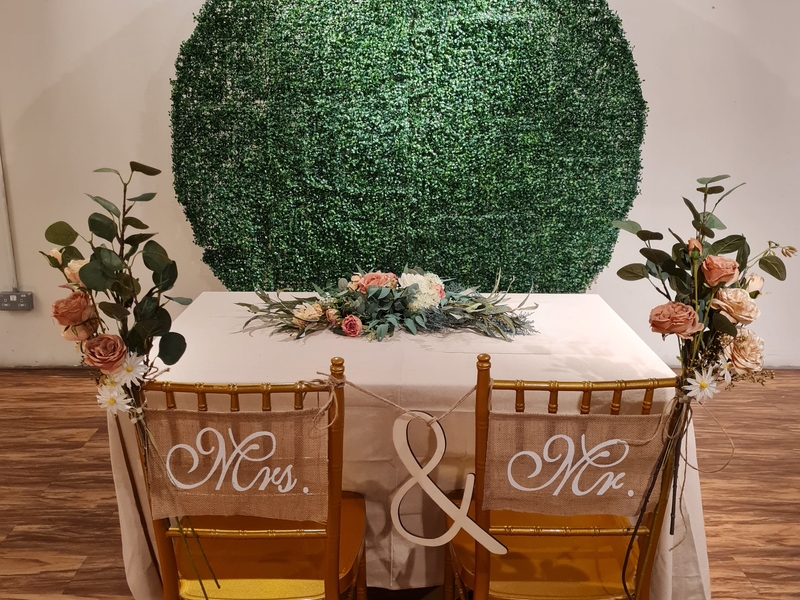 Mrs & Mr chairs and white table with floral decoration