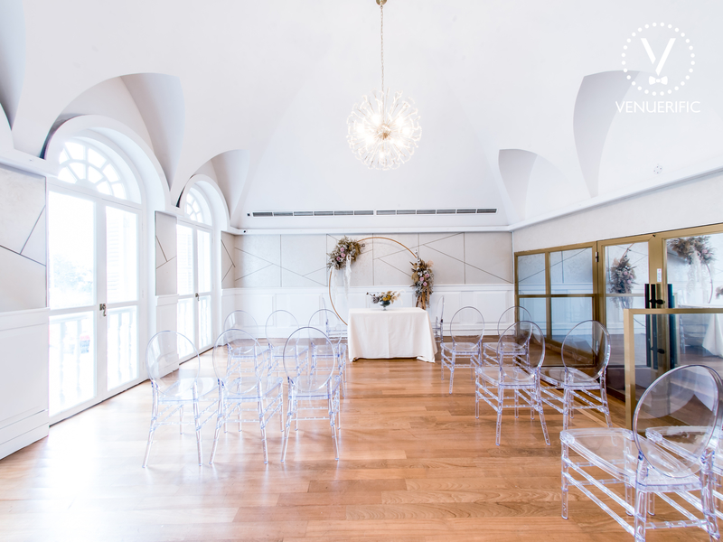 Wedding hall with clear plastic chairs and white table