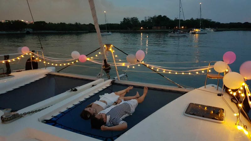 beautiful boat with fairy lights and couple laying on the deck for solemnisation 