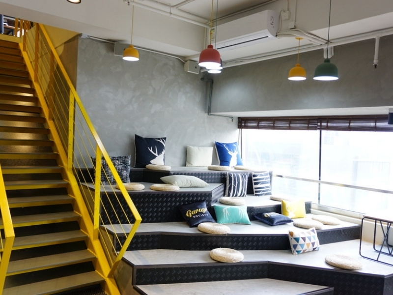 colourful cushion in a resting area beside yellow stairs