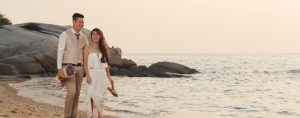 couple walking on a beach for pre-wedding photoshoot